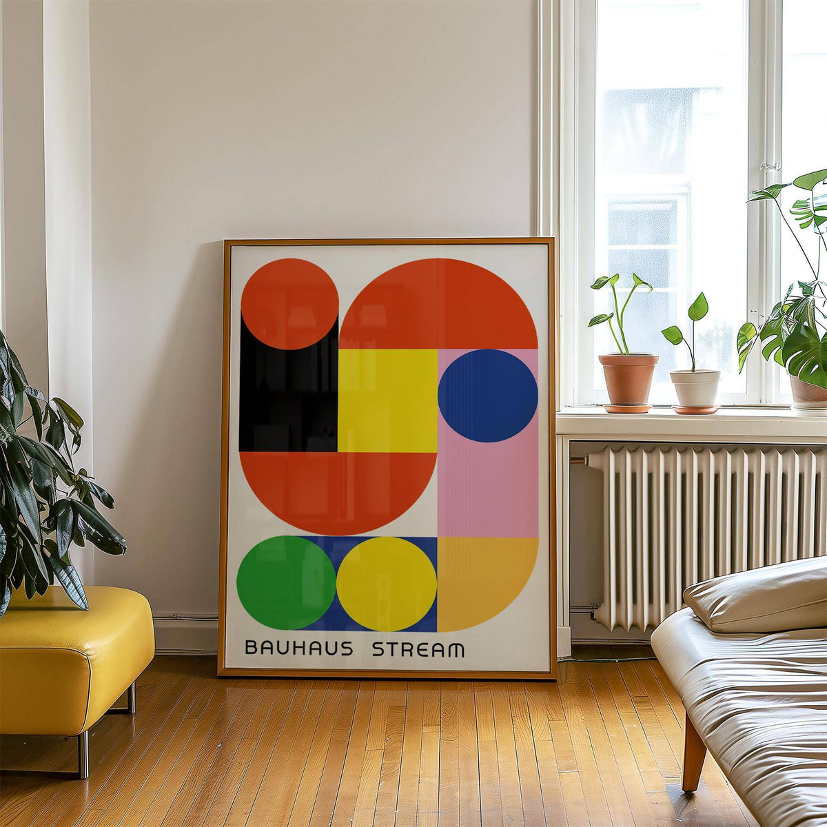 Geometric wall decal leaning on floor with colourful shapes near yellow stool and plants on window sill
