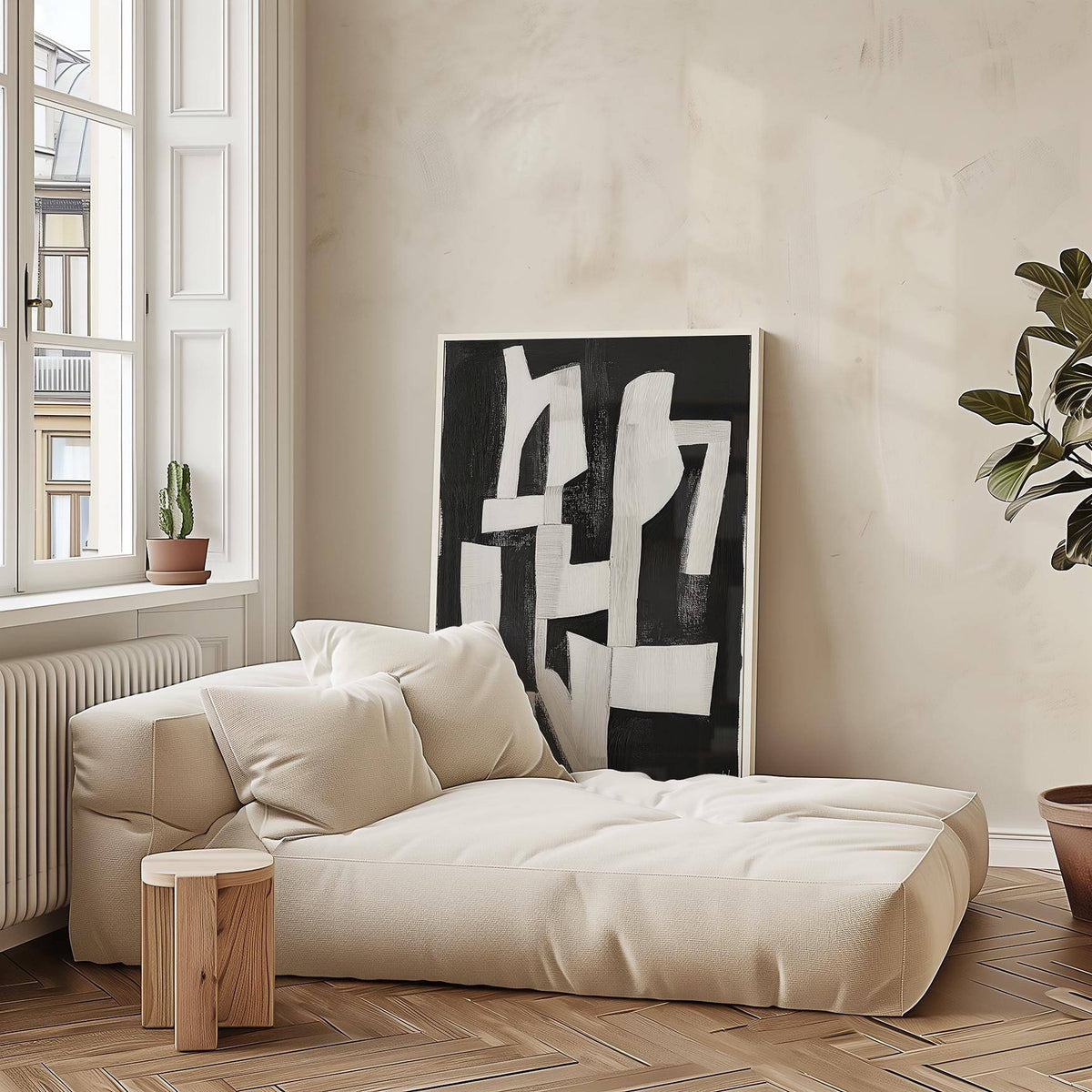 Wabi Sabi wall art with white abstract shapes leaning on the wall near a beige sofa