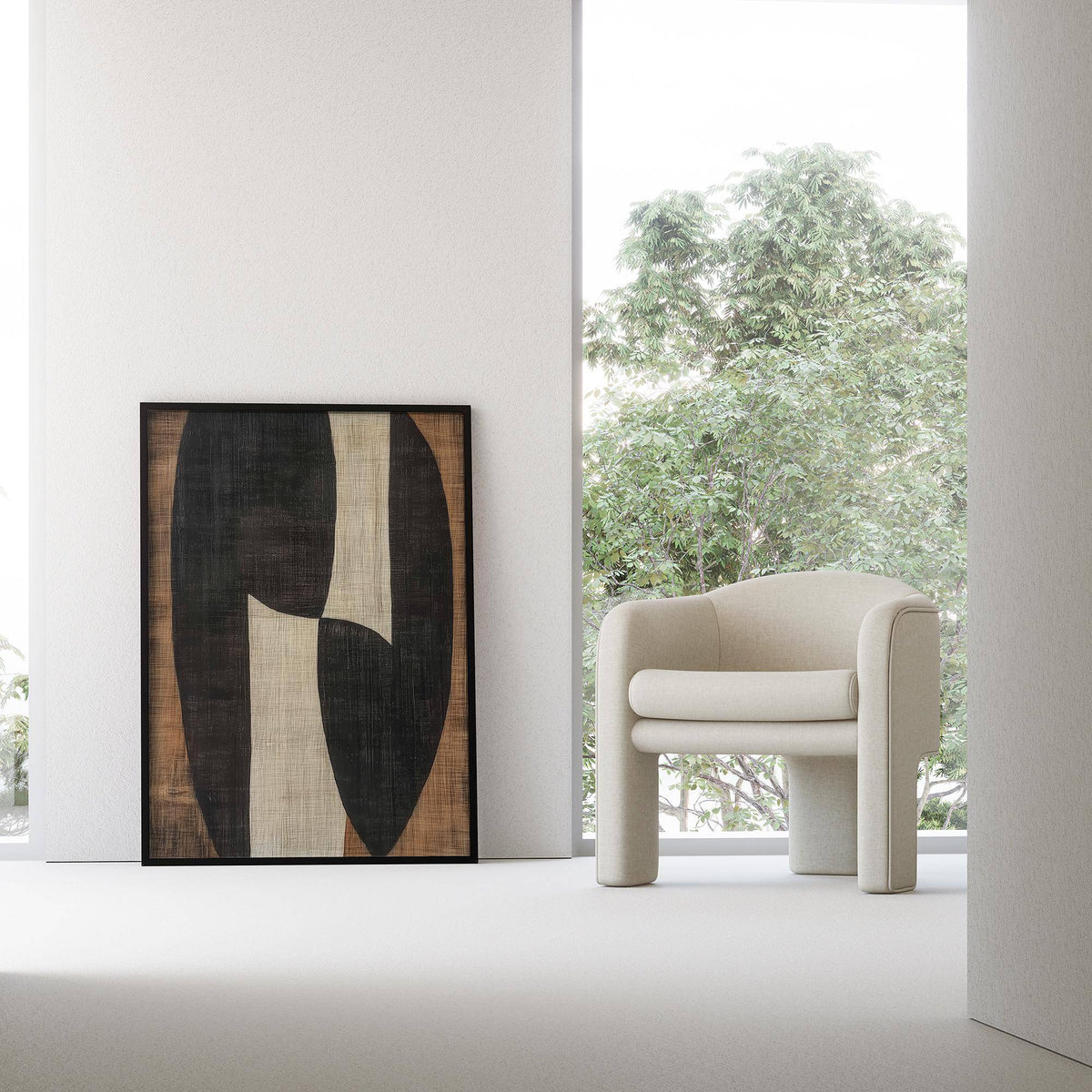Zen wall art of abstract organic shapes in black beige and brown leaning on a wall next to a cream armchair