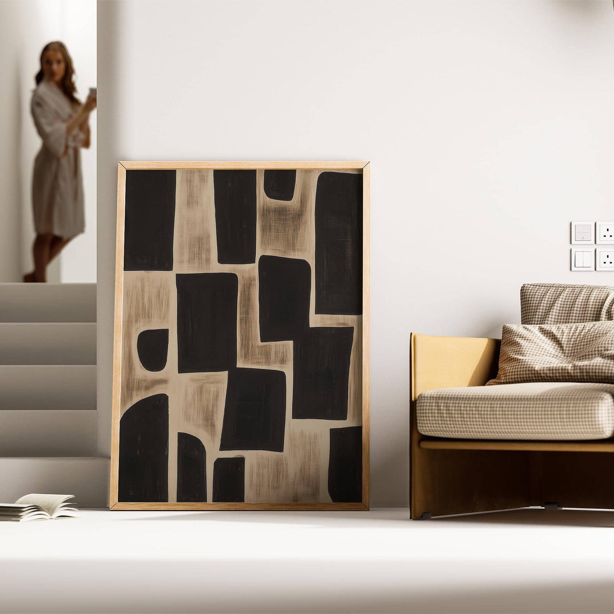 Wabi Sabi Artwork print with black abstract shapes leaning on the floor next to a beige sofa