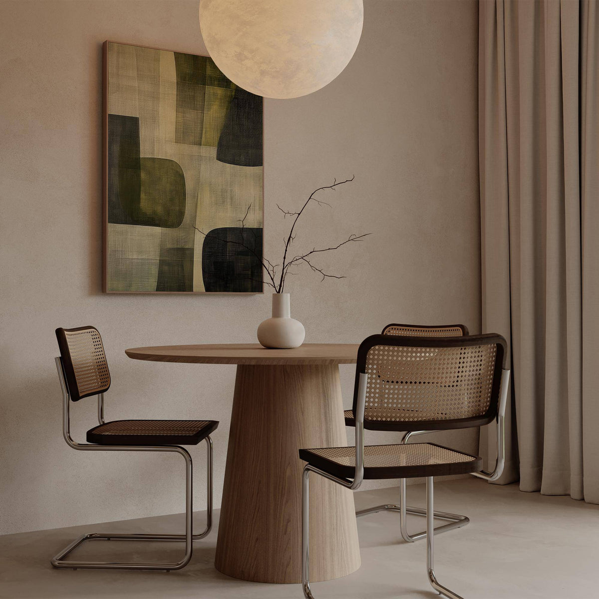 Abstract art print with green and black shapes above a wooden dining table and chairs with cane backs