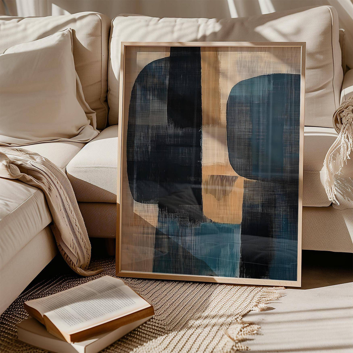 Wabi Sabi Painting leaning on a patterned rug by an open book and cream sofa with cushions