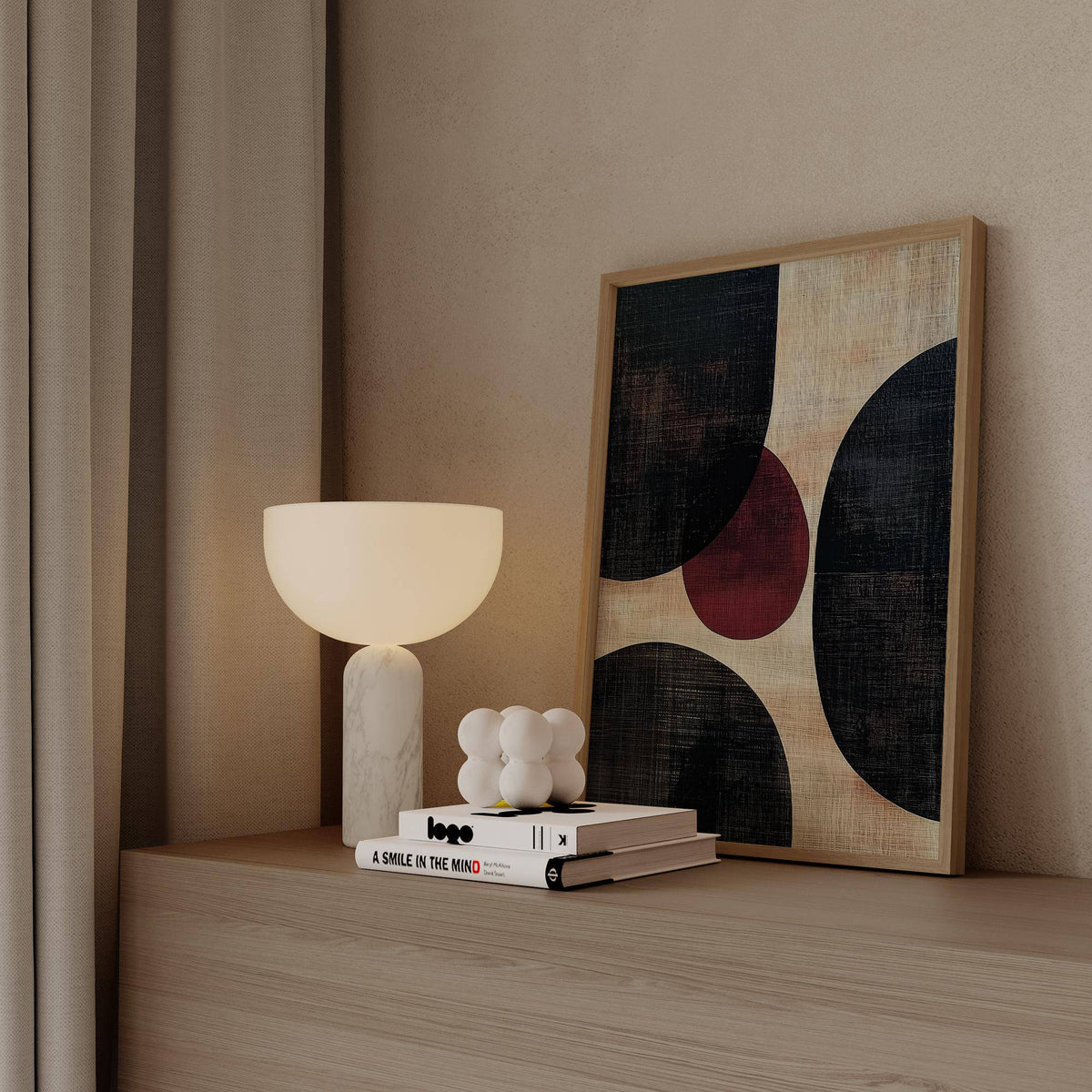 Wall Art Abstract leaning on a shelf with a rounded cream lamp and neutral background