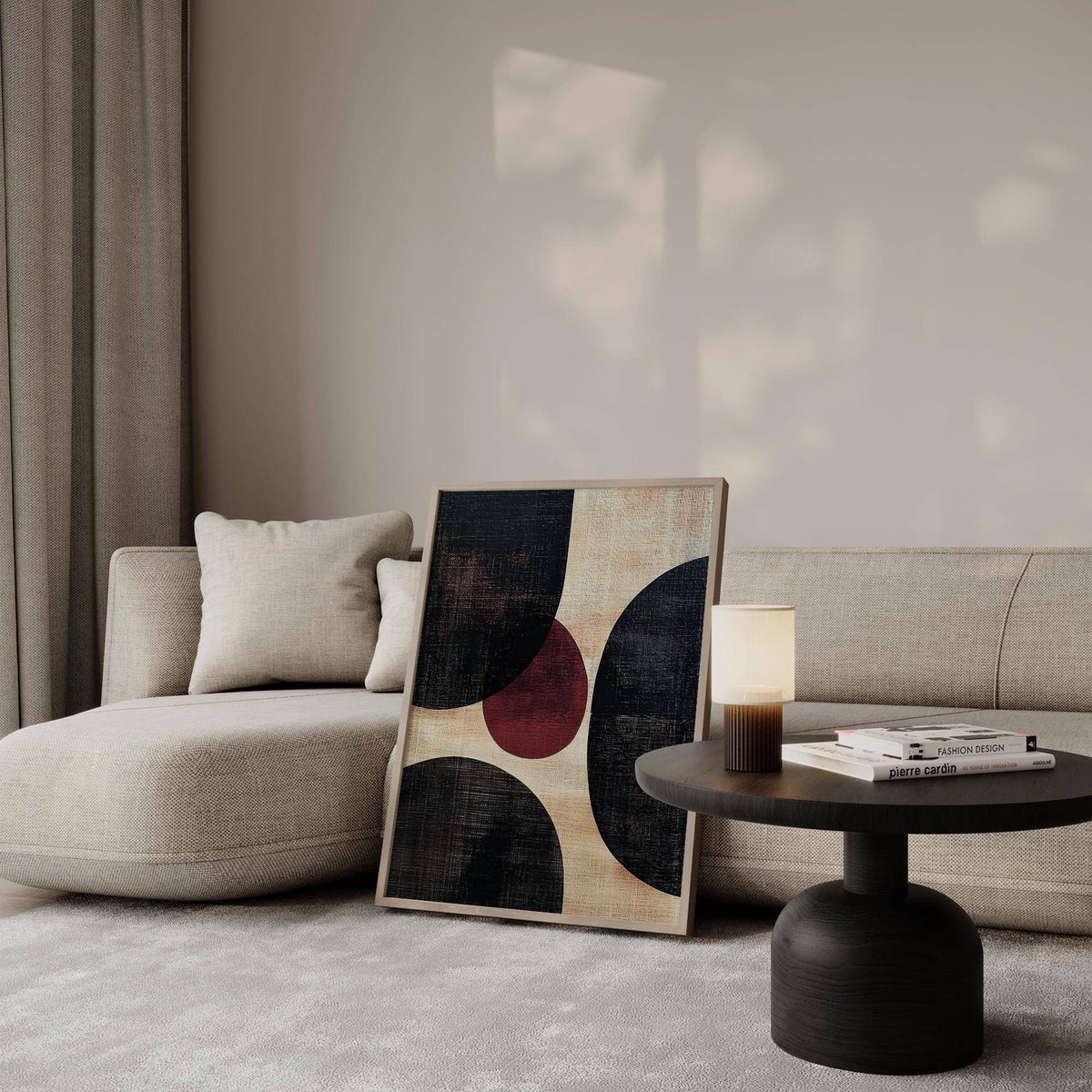 Wall Art Abstract leaning on a beige sofa with a dark side table and lamp nearby