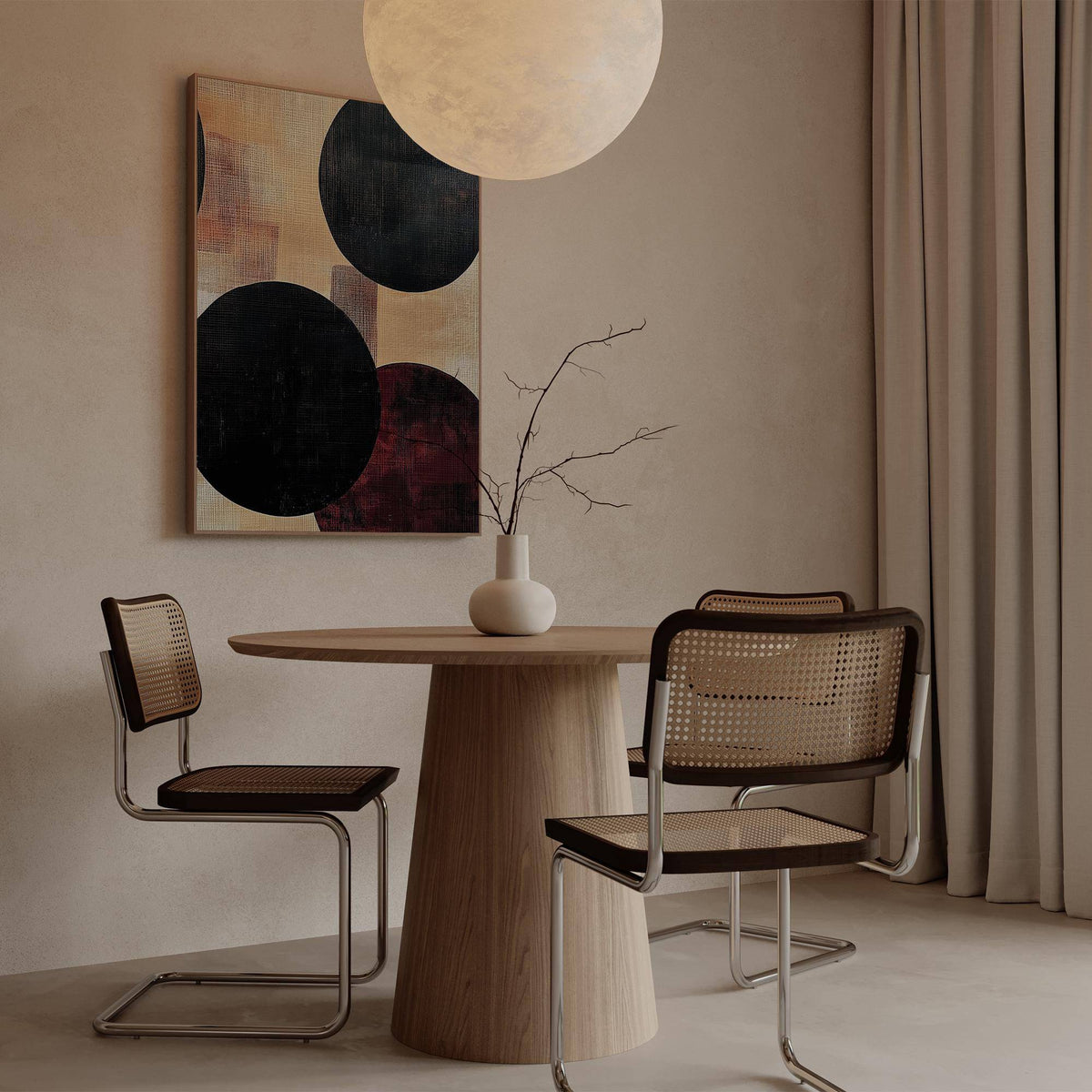 Abstract Neutral Art print with bold black circles above a round wooden table in a minimalist dining space