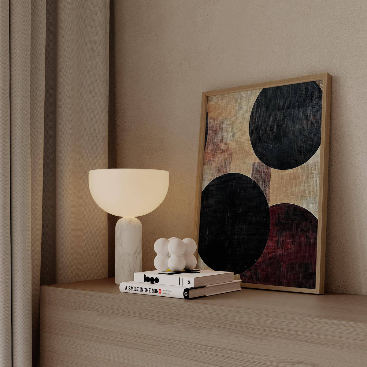 Abstract Neutral Art leaning print with bold black circles in beige and dark red near a white lamp