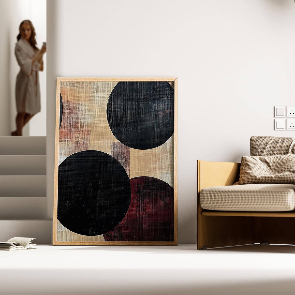 Abstract Neutral Art print with bold black circles leaning on the floor next to a sofa