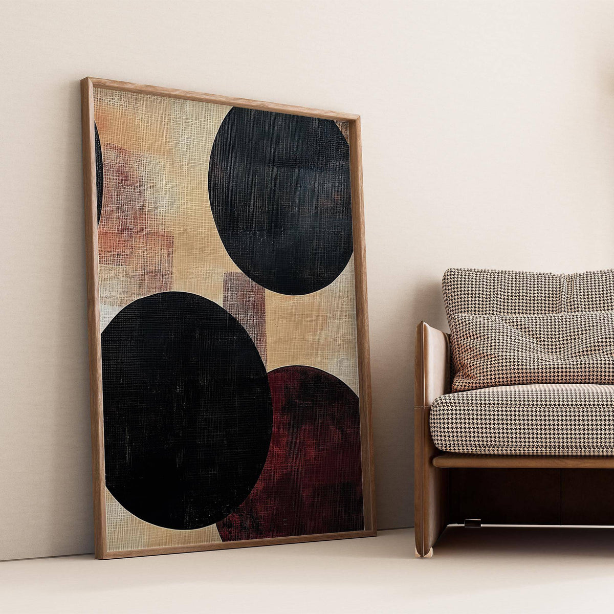 Abstract Neutral Art leaning print with bold black circles next to a checked sofa