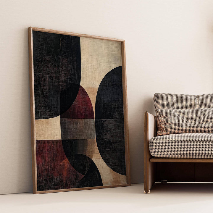 Print leaning on floor of wall posters for living room with abstract shapes in black beige and red near a patterned sofa