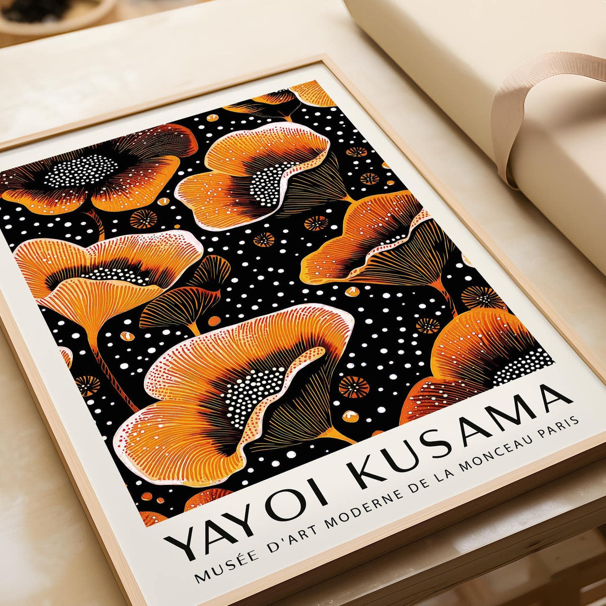 Close-up of Orange Print with stylised orange flowers and black dotted background on cream surface