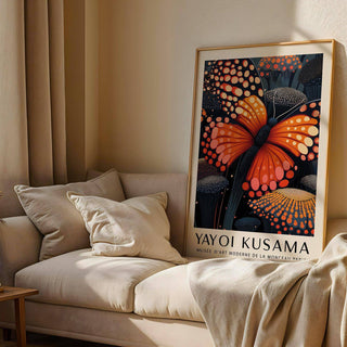 Poster Butterfly print leaning on a sofa with cream cushions and a soft throw in a sunlit room