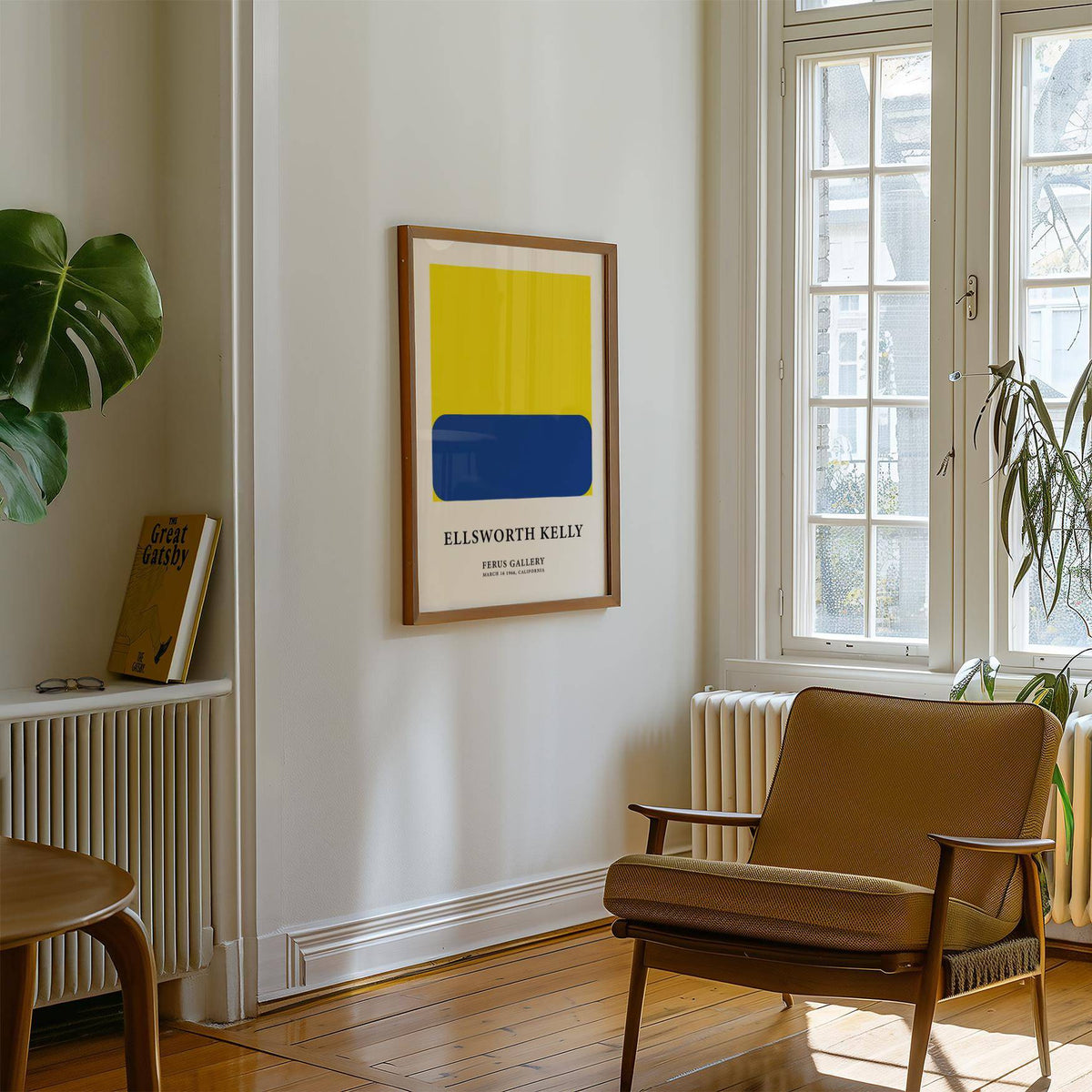 Minimalist artwork with blue rounded rectangle on yellow square above a bookshelf in a bright room