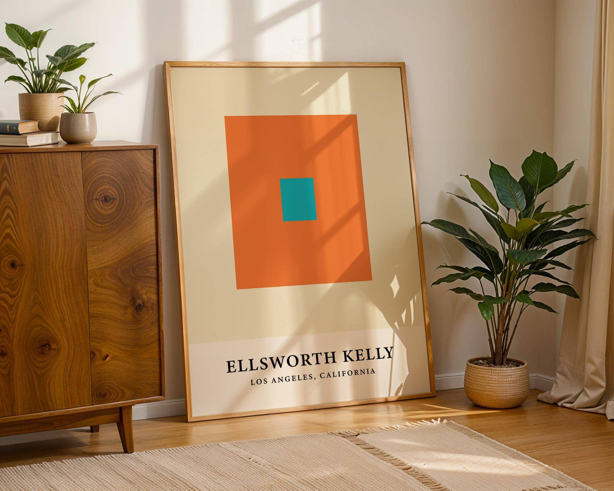 Print leaning on a floor next to a green plant with orange and blue squares Ellsworth Kelly artwork