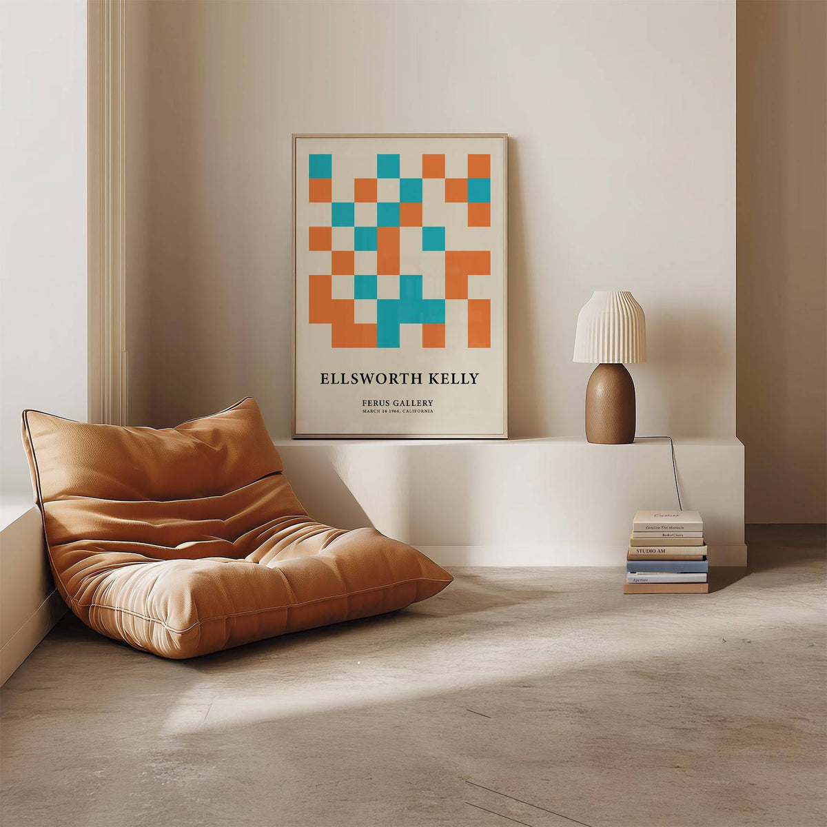 Large geometric wall art leaning on a shelf with blue and orange squares beside a white lamp and books