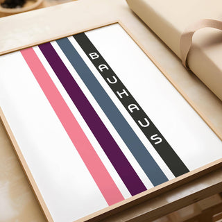 Framed close-up of geometric art wall with vertical coloured stripes and BAUHAUS text next to gift wrap