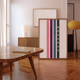 Geometric Art Wall print leaning on floor with vertical stripes and typographic text in wood frame near a yellow lamp