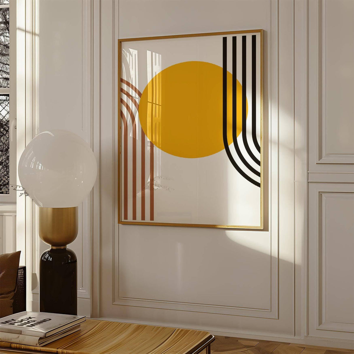 Bauhaus Sun Print hanging with warm orange circle and black and brown lines beside a modern lamp