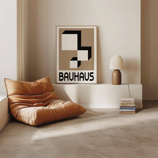 Geometric wall hanging of white and black blocks in a minimalist room with a modern brown armchair