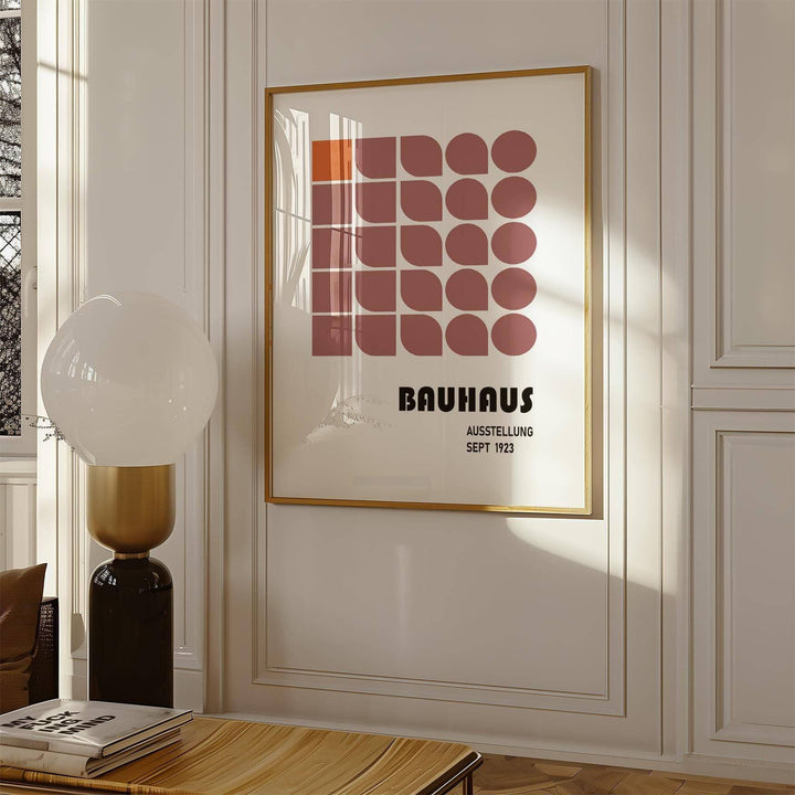 Wall Hanging Geometric framed print with minimalist red and orange shapes above a wooden table in a living room