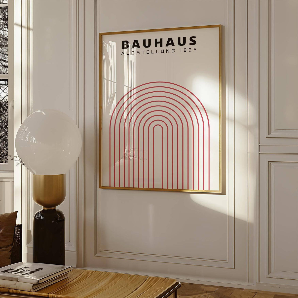 Original Bauhaus Poster print with red concentric arch lines and typographic text hanging on a wall beside a lamp