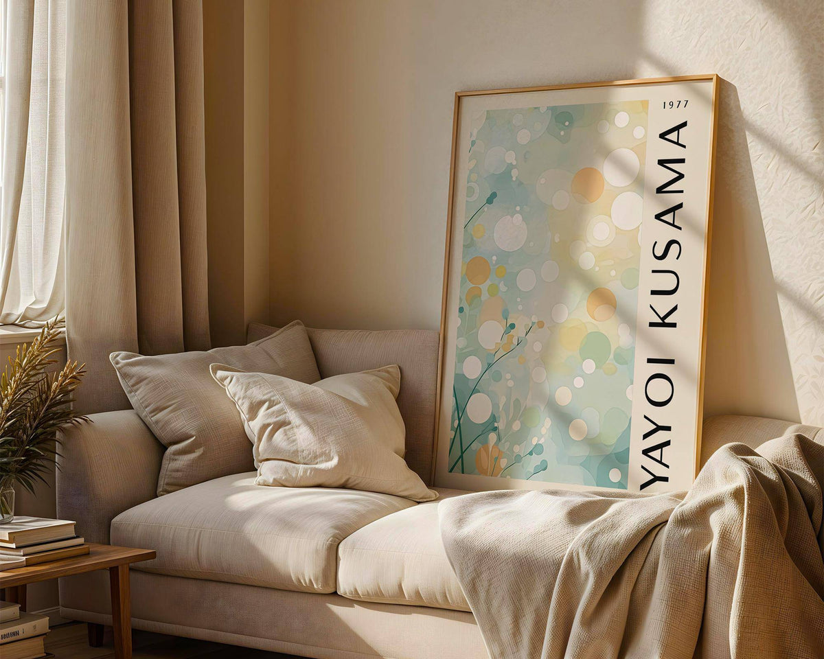 Print leaning on a sofa of pastel nature abstract circles with light blue and beige hues in a living room