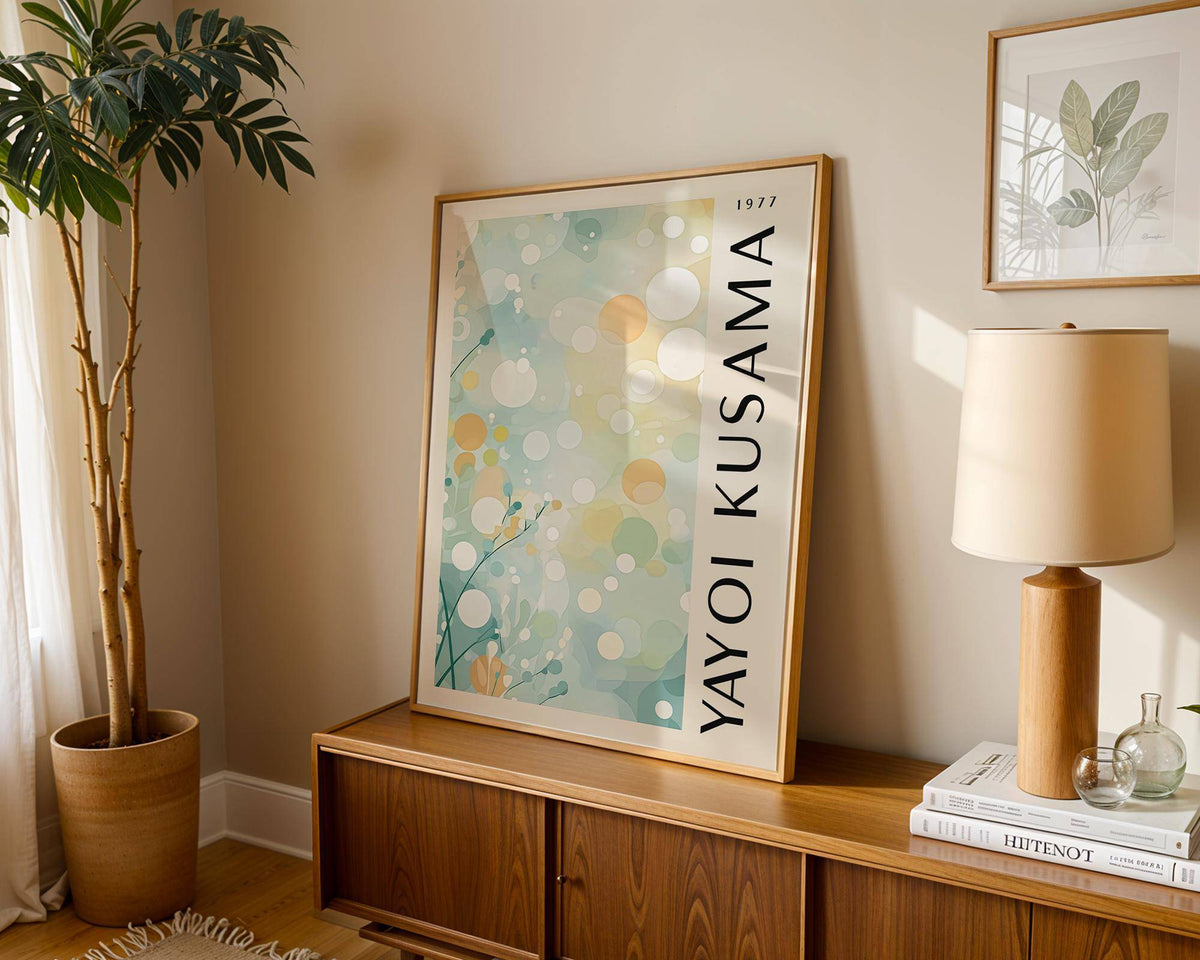 Light Blue Wall Decor leaning on wooden cabinet with a lamp and books beside it