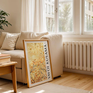 Yellow Nature Art framed print of abstract autumn branches leaning against a sofa in a bright living room
