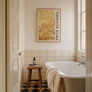 Print on a wall in a bathroom of yellow autumn branches artwork above a wooden stool with toiletries