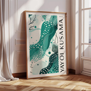 Black White and Green Poster leaning on wooden floor with sunlit wall and white curtain nearby