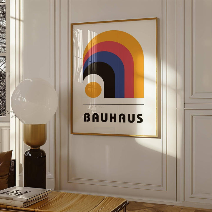 Bauhaus Art Posters print on a wall with colourful arches beside a brown and gold lamp