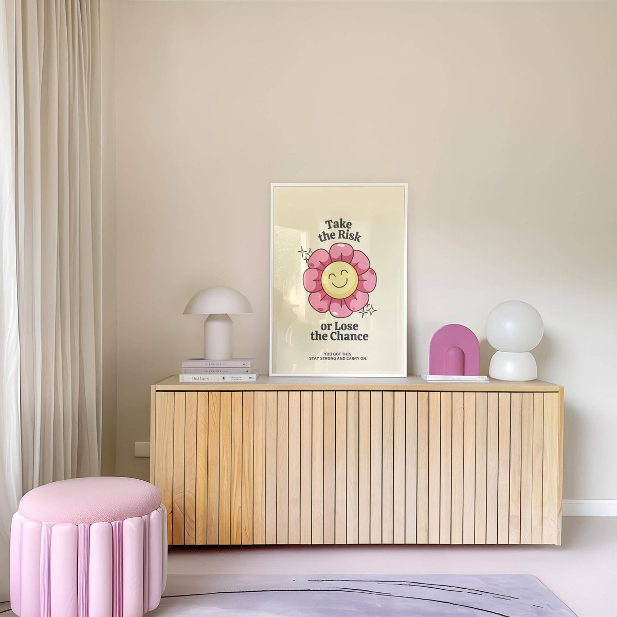 Motivational Quotes wall art with a smiling pink flower on a shelf above a wood cabinet