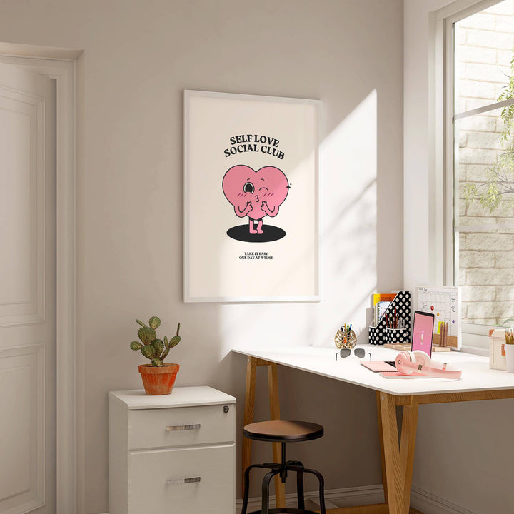 Inspirational Quotes wall decor featuring a winking pink heart character in a minimalist style above a desk with a cactus