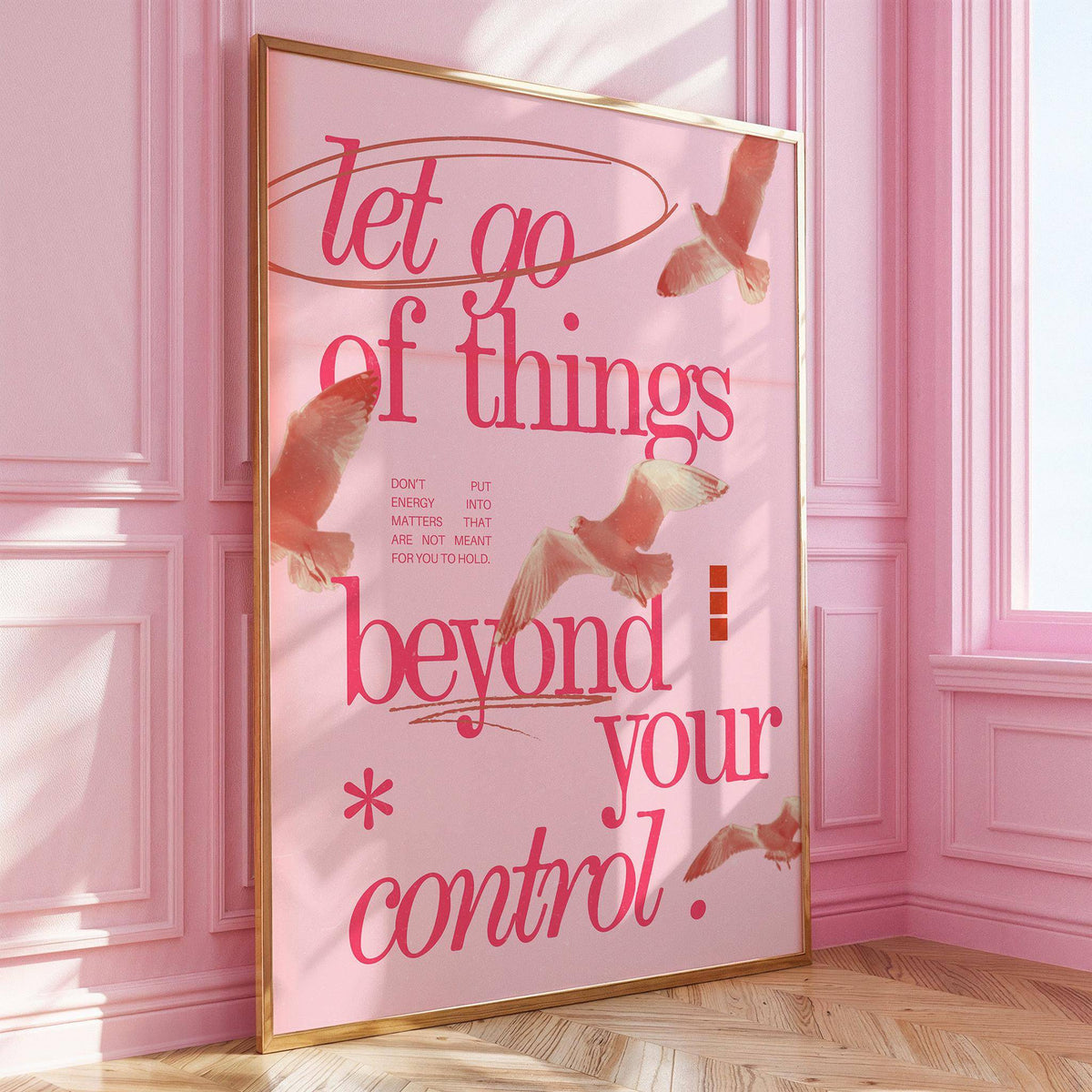 Framed print with pink and red typography quote and birds leaning against a pink wall