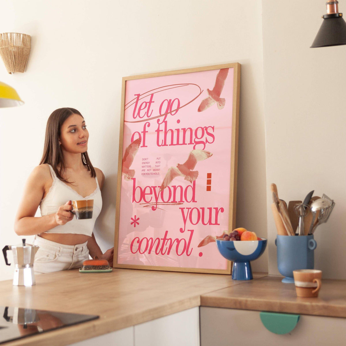 Posters with Inspirational Sayings leaning on a kitchen counter near a fruit bowl and utensils