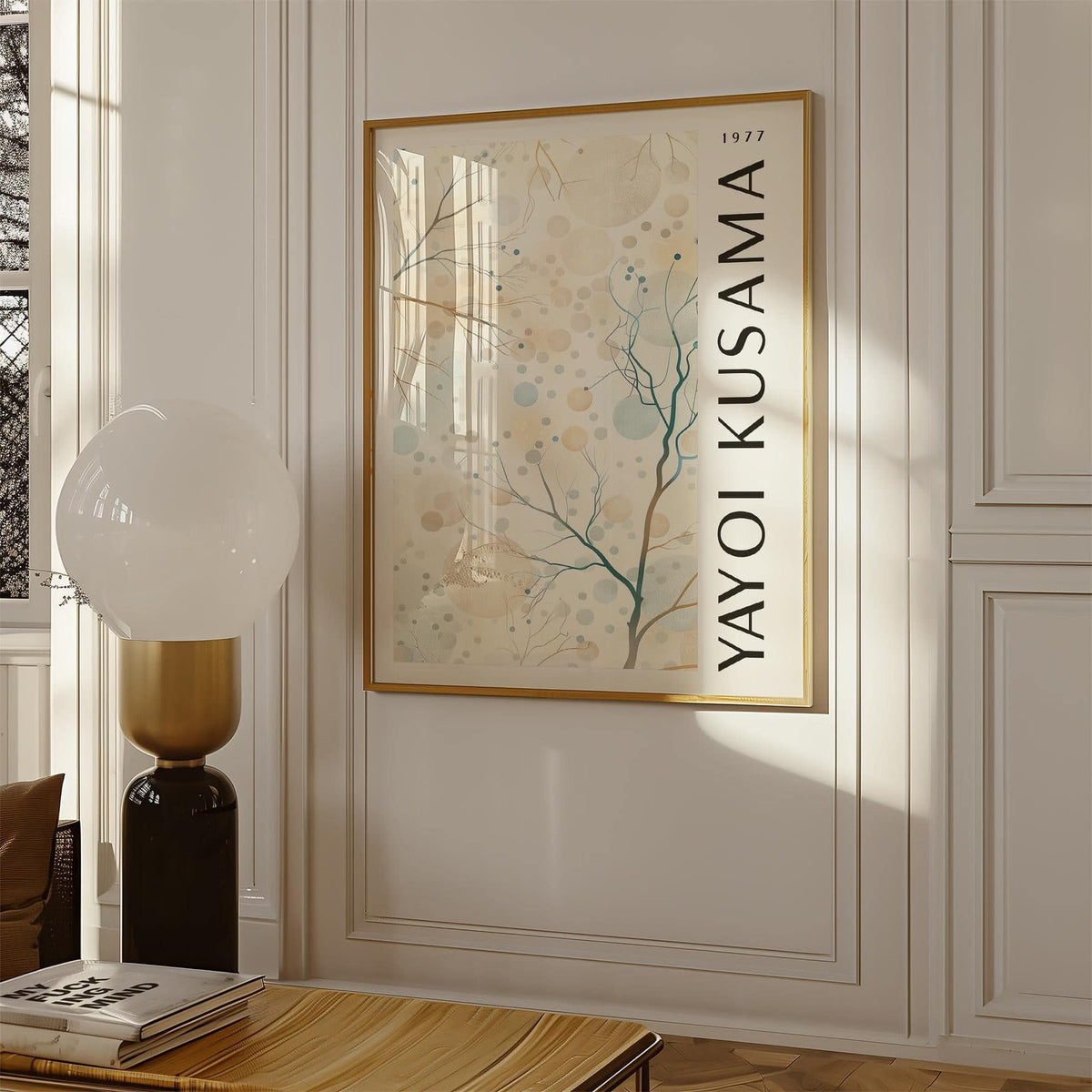 Nature prints framed print with abstract tree branches and circles in soft beige and blue next to a lamp on a carved white wall