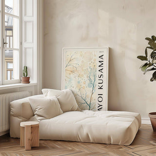 Nature Prints leaning print of abstract tree branches with circles beside a beige sofa and wooden stool