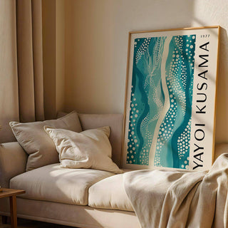 Abstract picture leaning on a sofa displaying teal and white abstract pattern with dots and wavy lines