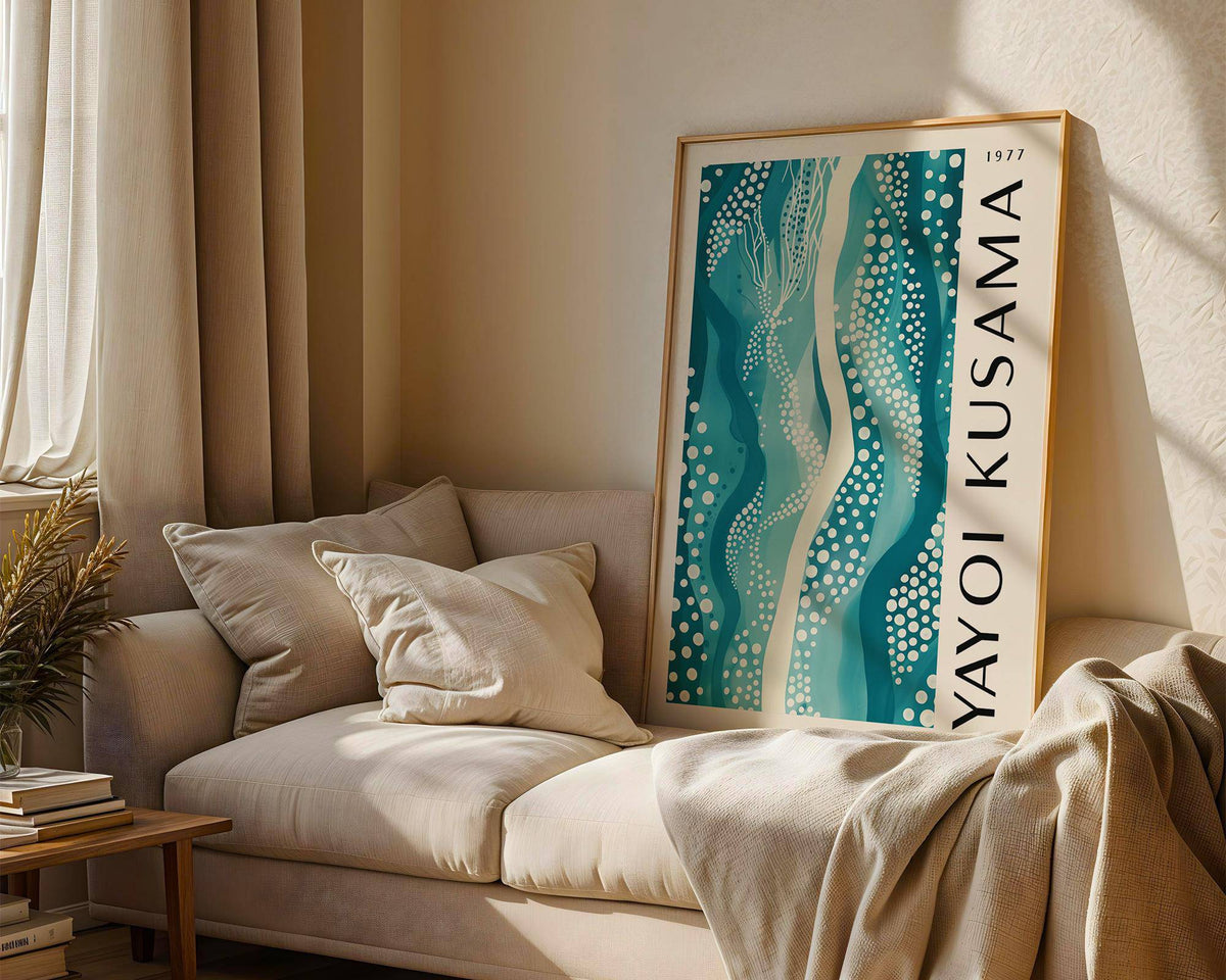 Abstract picture leaning on a sofa displaying teal and white abstract pattern with dots and wavy lines