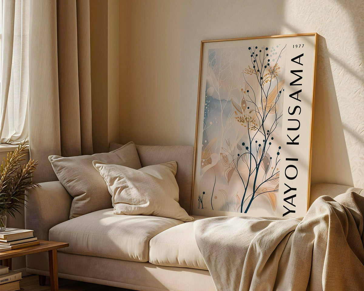 Large Neutral Wall Art leaning on sofa with neutral cushions and a plant nearby in a softly lit room