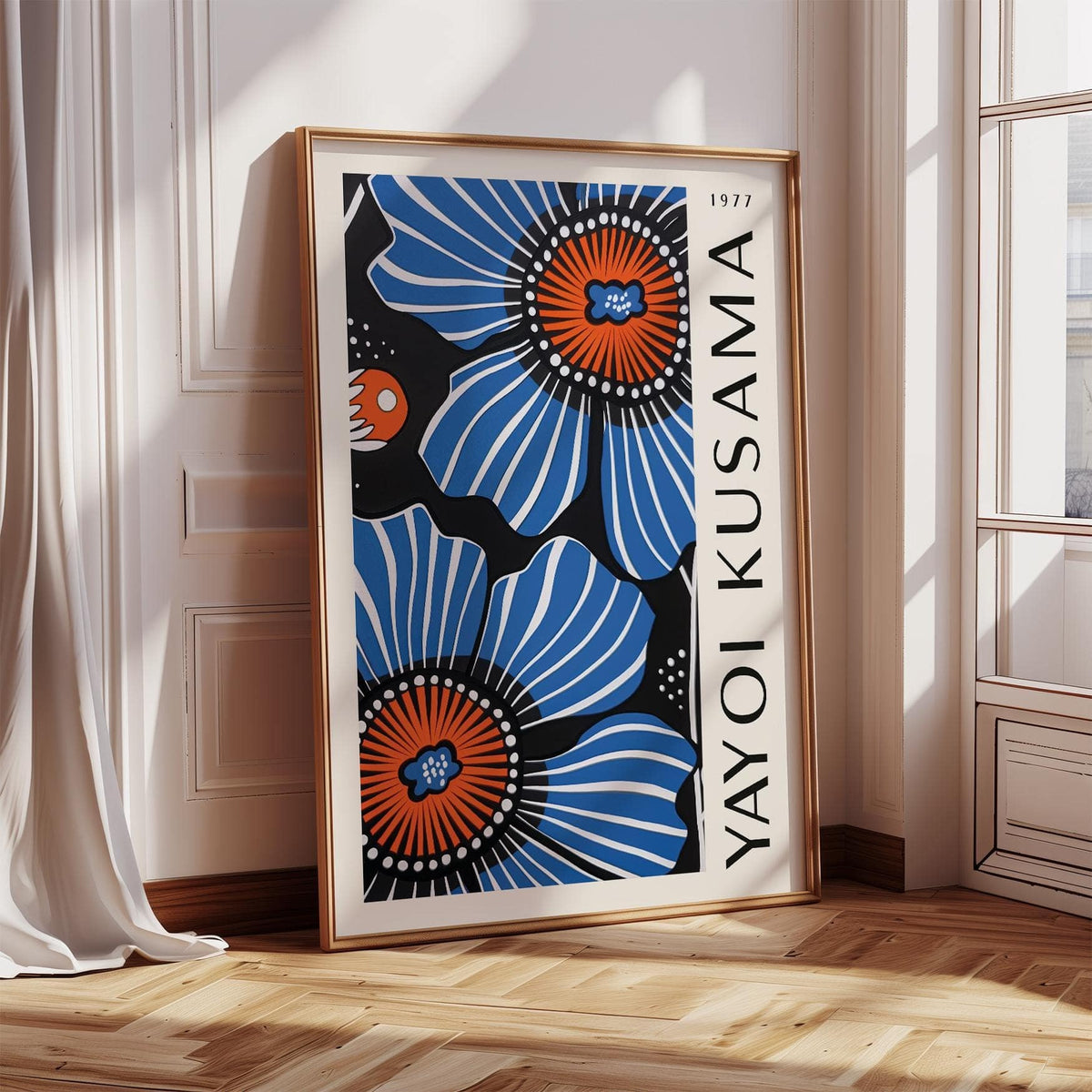Blue floral home decor print leaning on the floor with blue poppy flowers and a wooden frame in a bright room