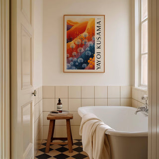 Blue Orange wall decor above a wooden stool in a bathroom with white tiles and a rolled towel on the bath