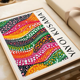 Framed Polka Dot Art print with dotted colourful waves leaning on a beige sofa