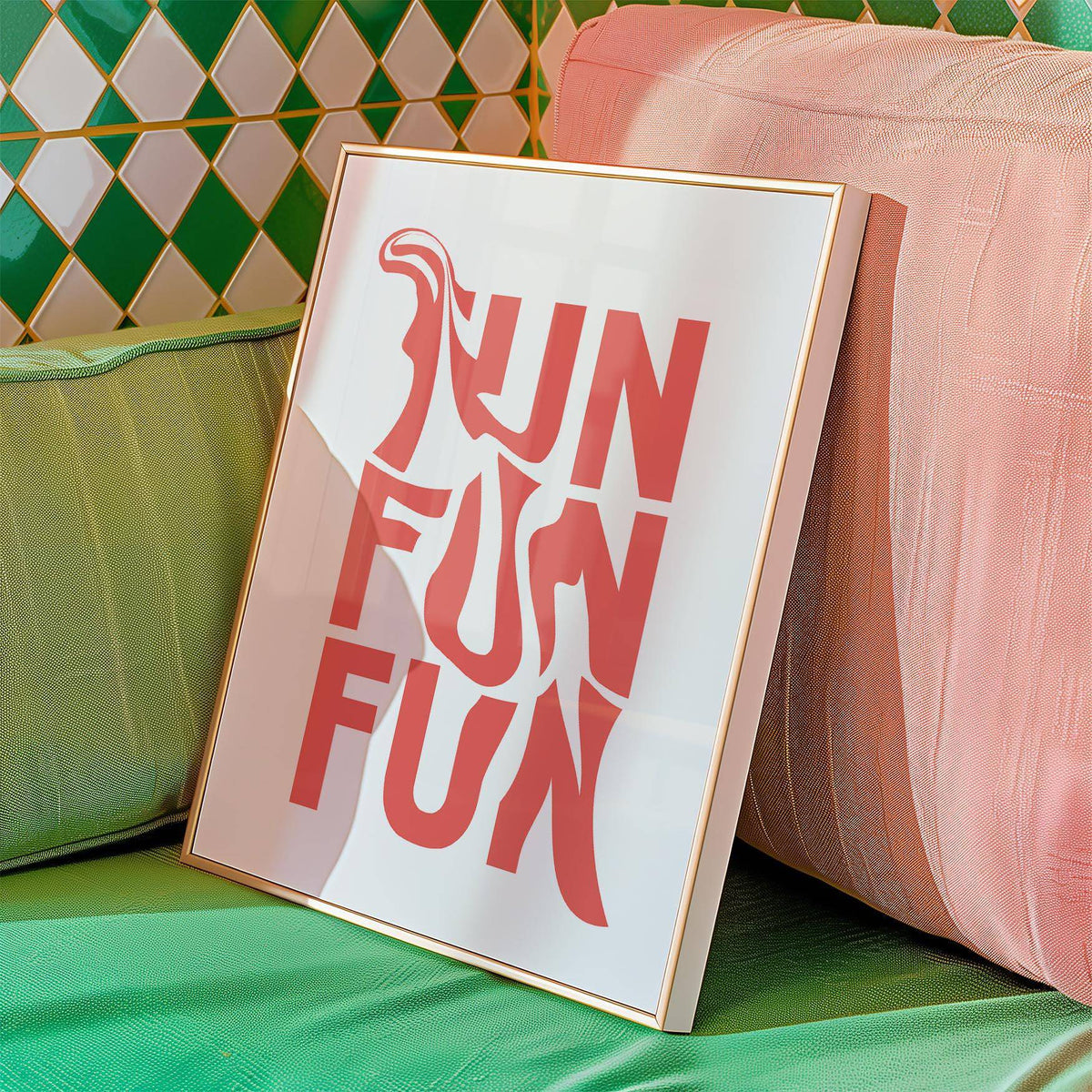 Framed print with fun typography in coral leaning against pink and green cushions
