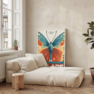 Print leaning on the floor showing butterfly wall art with vintage blue and orange wings near a cream sofa and wooden stool