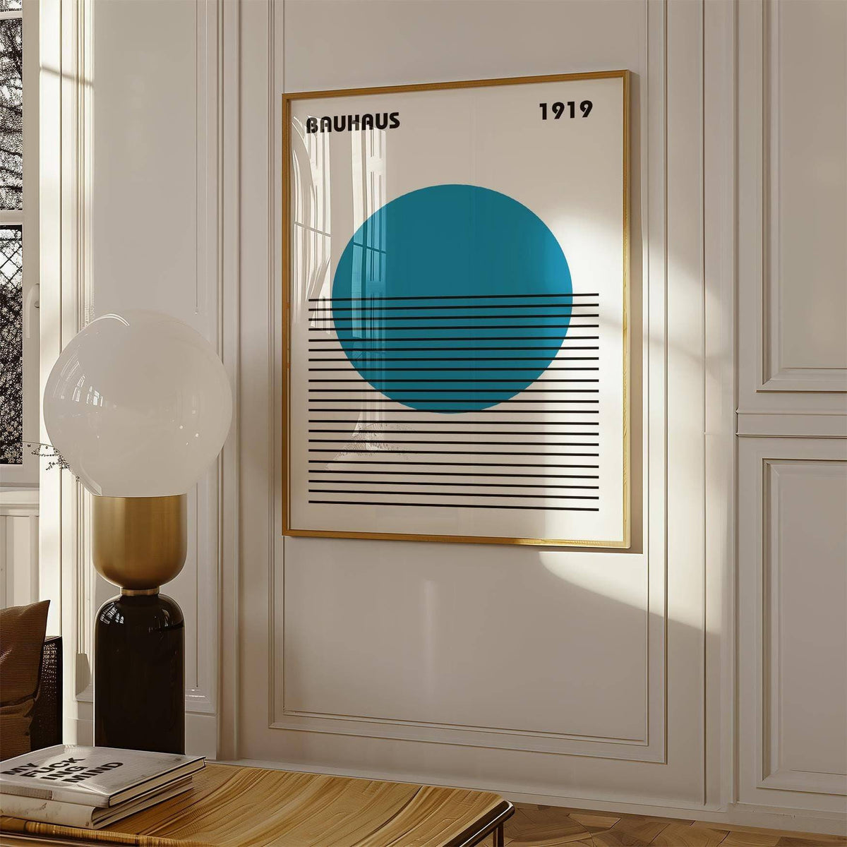 Minimlist Art framed print with blue circle and black lines hung on a white wall next to a modern lamp