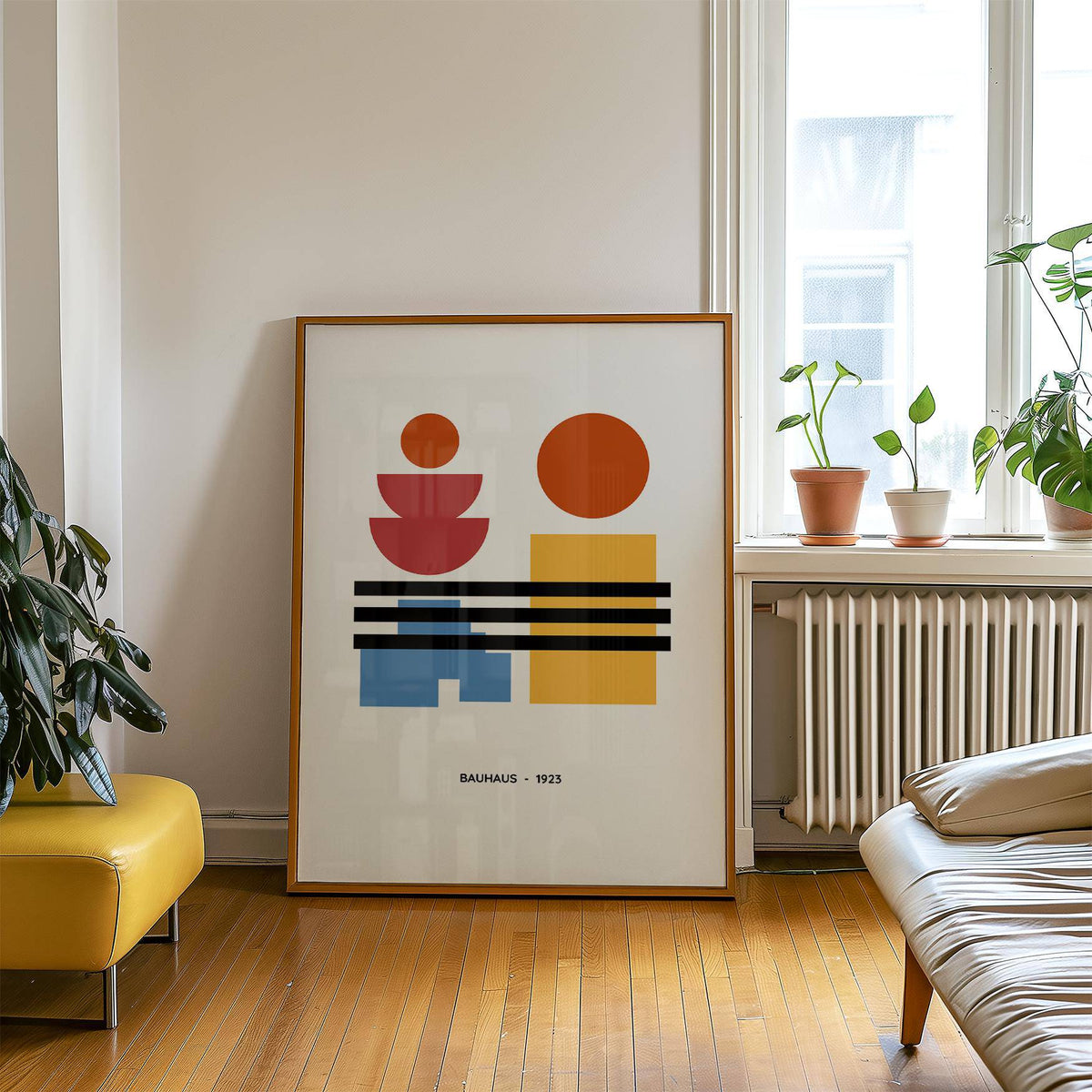 Minamalist Art print with primary geometric shapes leaning on a wooden floor next to a yellow chair