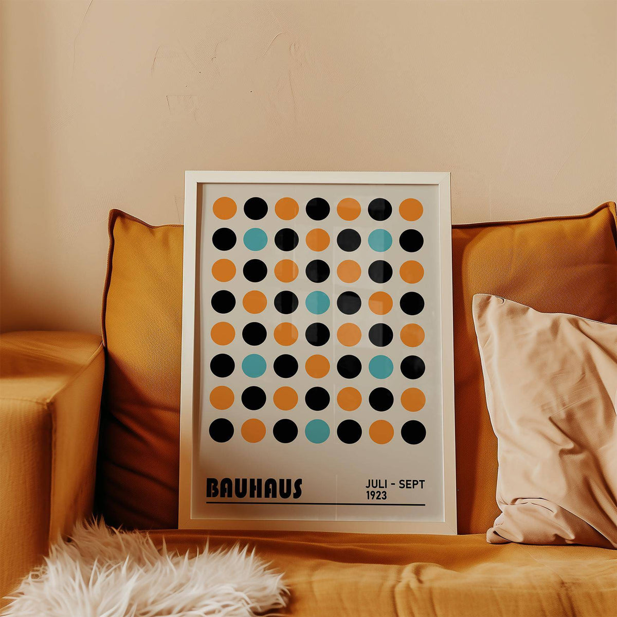 Framed geometric wall decor with multicolour dots pattern on a mustard sofa with cushions