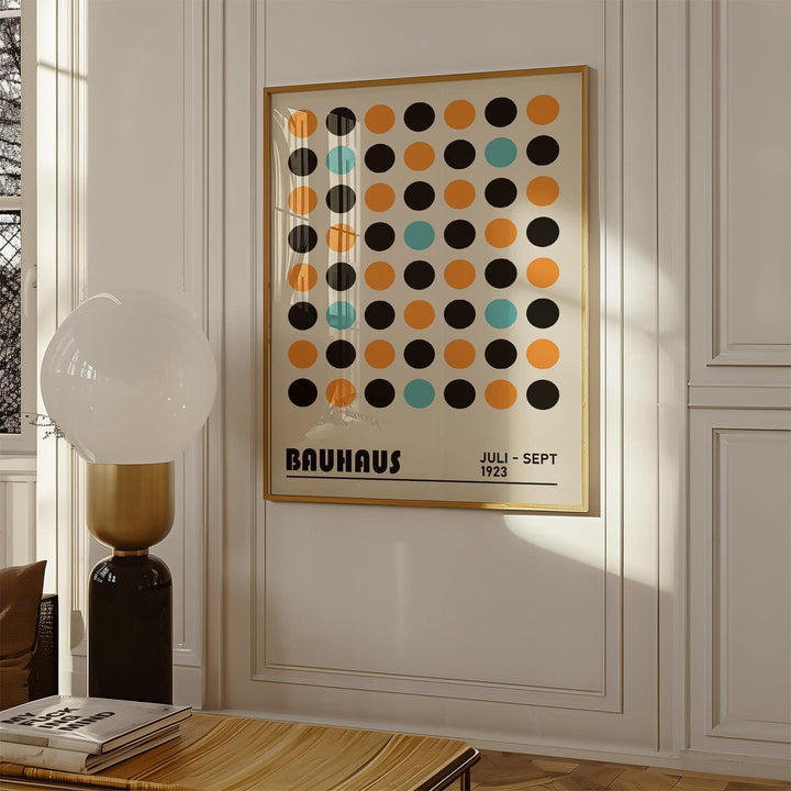 Geometric wall decor with multicolour dots and typographic text in a bright room beside a lamp