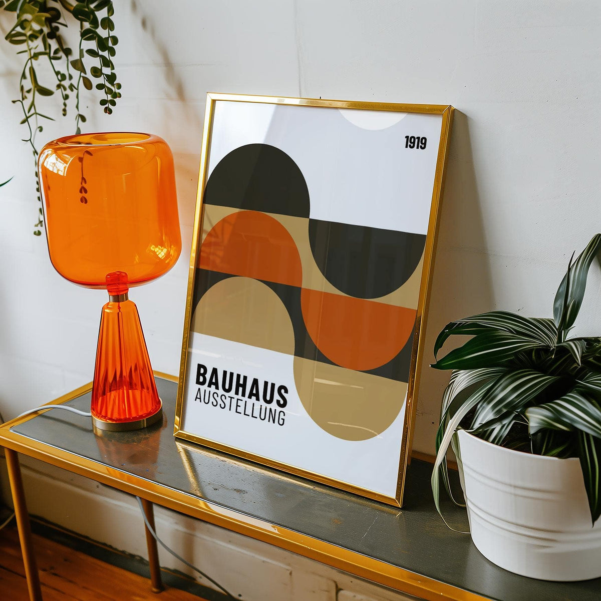 Artwork for the Wall framed print with abstract geometric shapes in orange beige and black beside an orange glass lamp