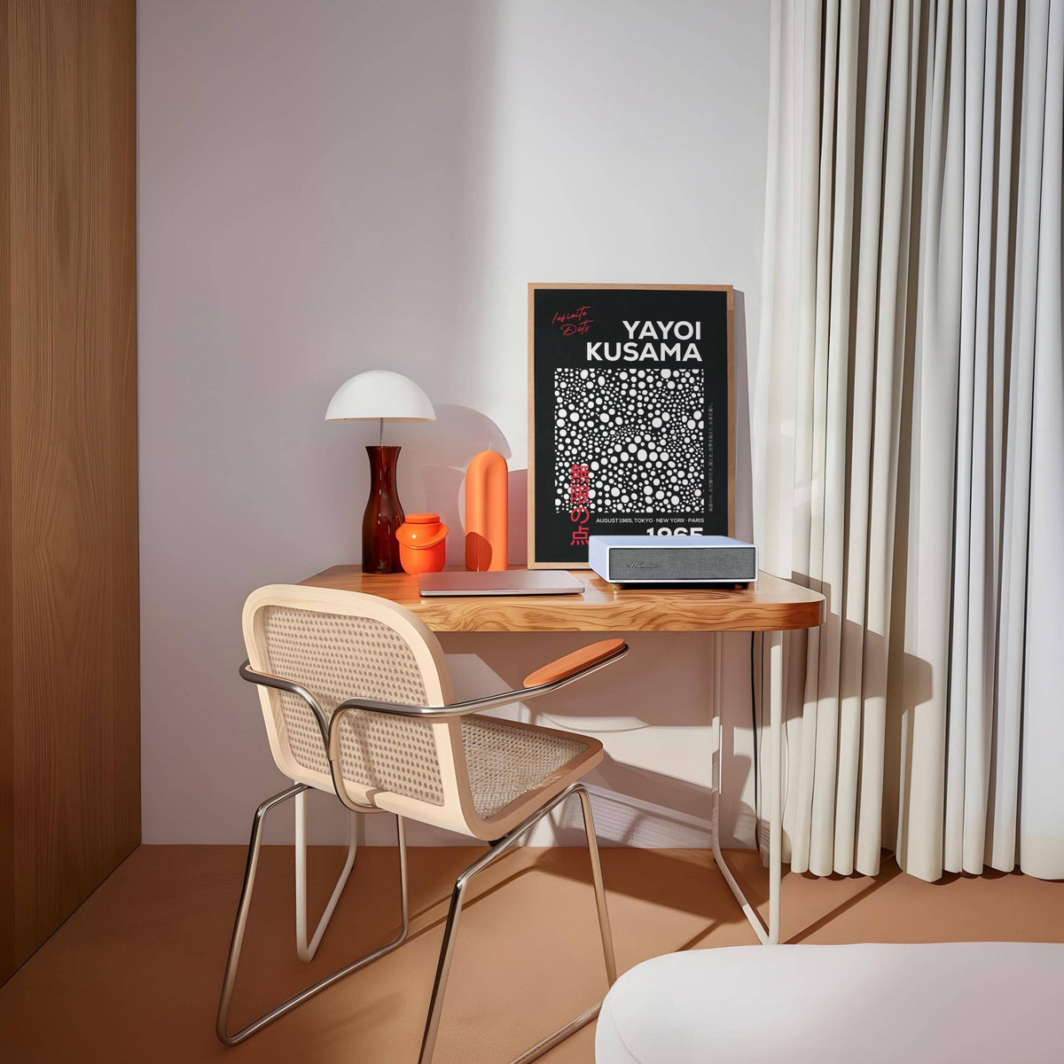 Wall art Polka Dots leaning on a wooden desk with an orange vase and white lamp in a room